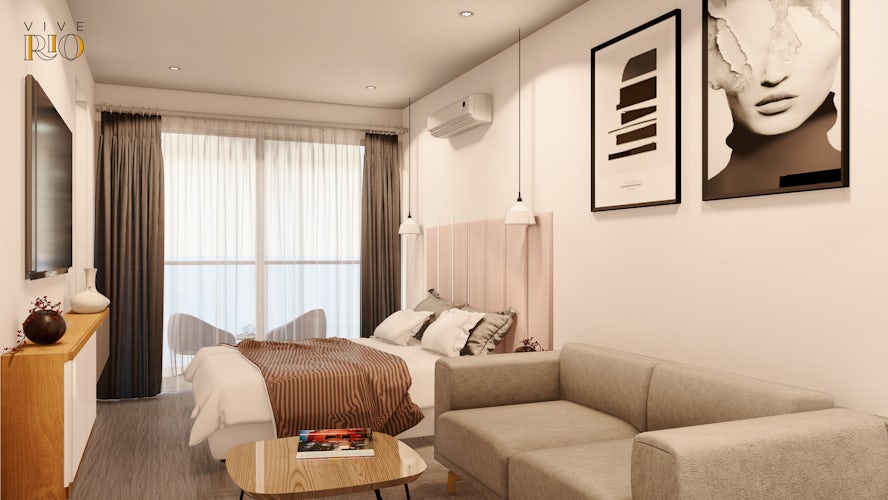 un dormitorio con zona de estar, buena ventilación natural, muebles