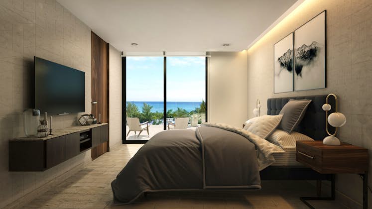 un amplio dormitorio con grandes ventanales, vista al sol